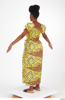 Dina Moses A poses dressed standing whole body yellow long…